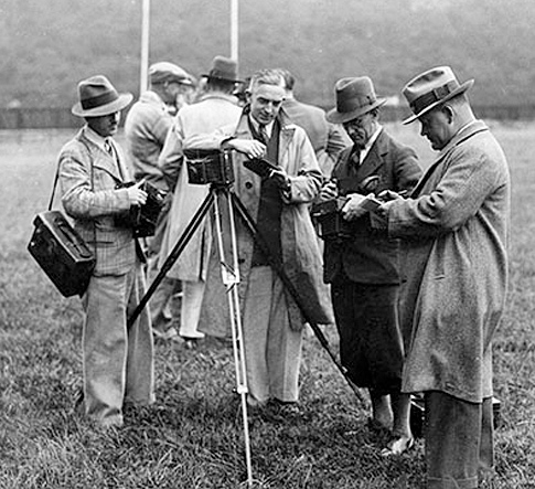 Leslie comparing notes with colleagues at a rugby match in the early 1950s.