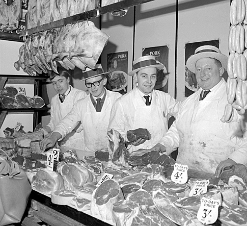 January 1966: Butchers with boaters in Morley Market.