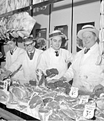 Butchers with boaters in Morley Market.